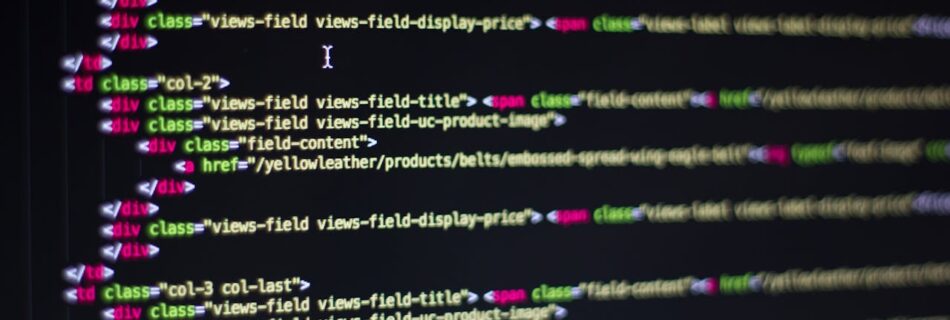 Detailed close-up of HTML code on a computer monitor, showcasing web development.